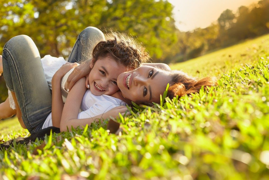 child and mother hugging outdoors