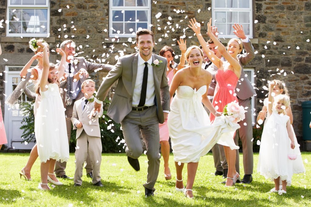 newly wed running with confetti throwing at them