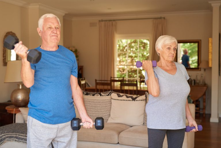 mature couple lifting weights