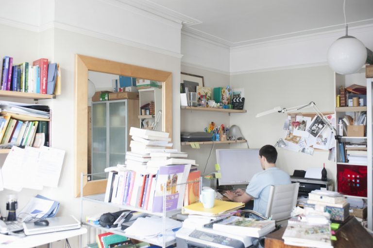 A home office space full of papers