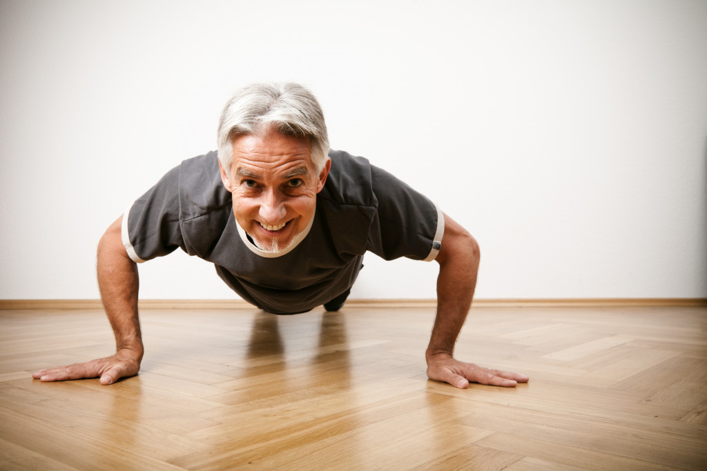a male senior citizen doing push ups